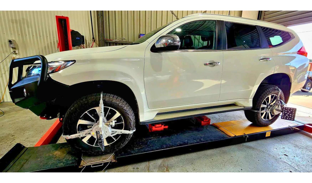White Mitsubishi Pajero receiving a Wheel Alignment by East-West Autos